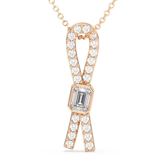 KATE EMERALD CUT DIAMOND SET IN A STUDDED BOW PENDANT, GOLD